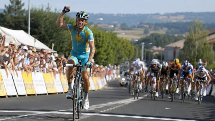 Alexander Vinokourov celebrates while crossing the finish line ahead of the peloton during Stage 13 of the 2010 Tour de France.