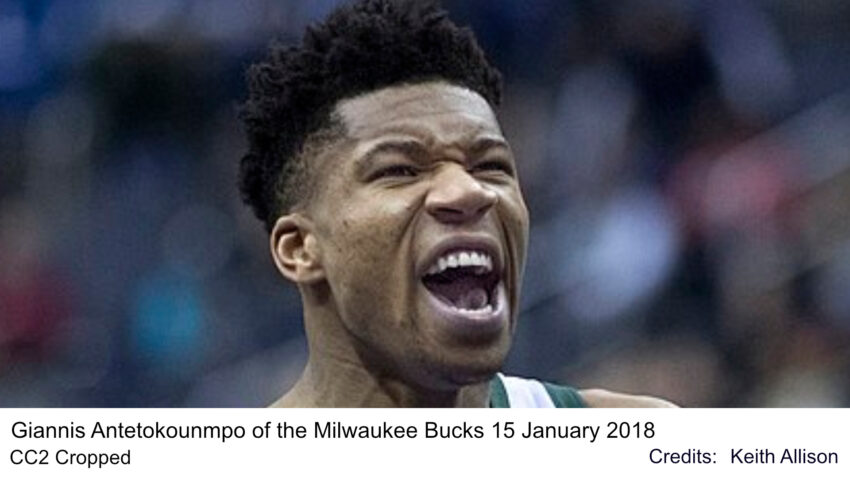 Giannis Antetokounmpo celebrating on the court with teammates,