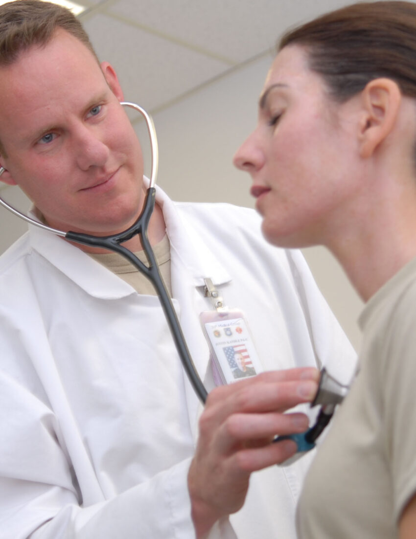 A physician performs a routine checkup on a patient at the medical clinic.