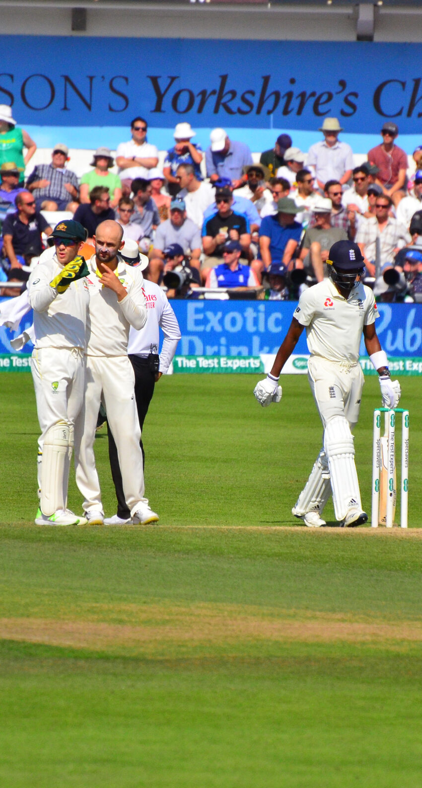 Australia captain / wicketkeeper Tim Paine and spin bowler Nathan Lyon of Australia discuss tactics as Jofra Archer walks to the wicket after the dismissal of Chris Woakes on Day 4 of the 3rd Test of the 2019 Ashes at Headingley