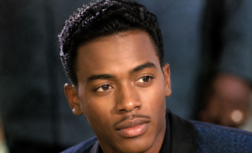 Portrait of actor Michael Wright, best known for playing Eddie King Jr. in The Five Heartbeats, looking off-camera in a dark blazer.