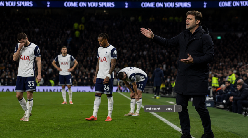 Tottenham players look dejected on the pitch as their new manager gestures from the touchline during a difficult period for the club.