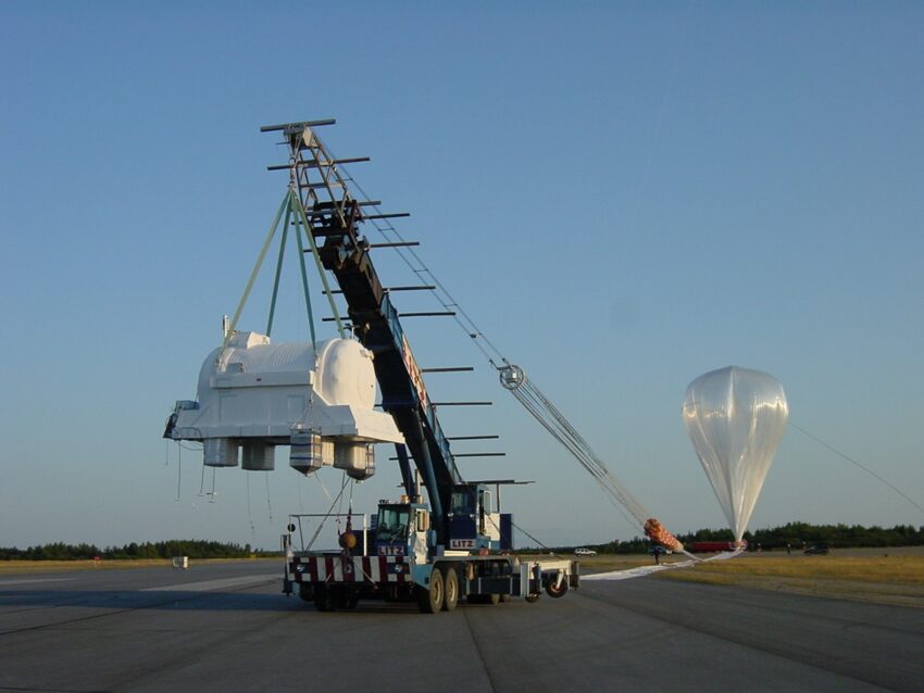 A large NASA scientific balloon rising into the sky near Lynn Lake, Manitoba, carrying a solar and heliosphere experiment to the edge of space.