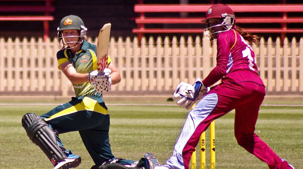 Australian batter Meg Lanning plays a sweep shot while Merissa Aguilleira of the West Indies keeps wicket during the 2014 West Indies tour of Australia at the North Sydney Oval.