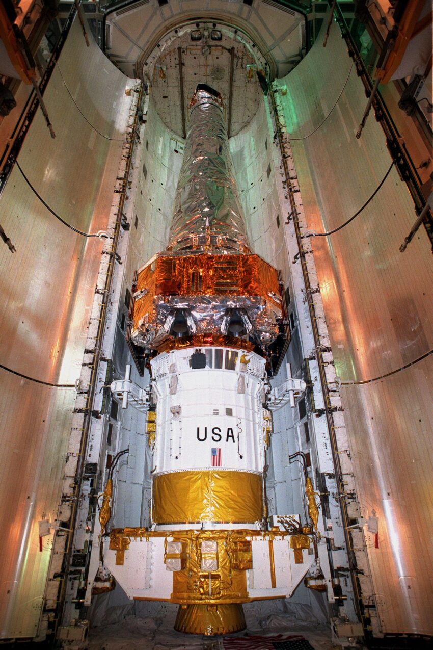 At Launch Pad 39-B, the Chandra X-ray Observatory sits inside the payload bay of Space Shuttle Columbia, waiting for the doors to close. Chandra is the primary payload on mission STS-93, scheduled to launch aboard Columbia July 20 at 12:36 a.m. EDT. The combined Chandra/Inertial Upper Stage, seen here, measures 57 feet long and weighs 50,162 pounds. Fully deployed with solar arrays extended, the observatory measures 45.3 feet long and 64 feet wide. The world's most powerful X-ray telescope, Chandra will allow scientists from around the world to see previously invisible black holes and high-temperature gas clouds, giving the observatory the potential to rewrite the books on the structure and evolution of our universe