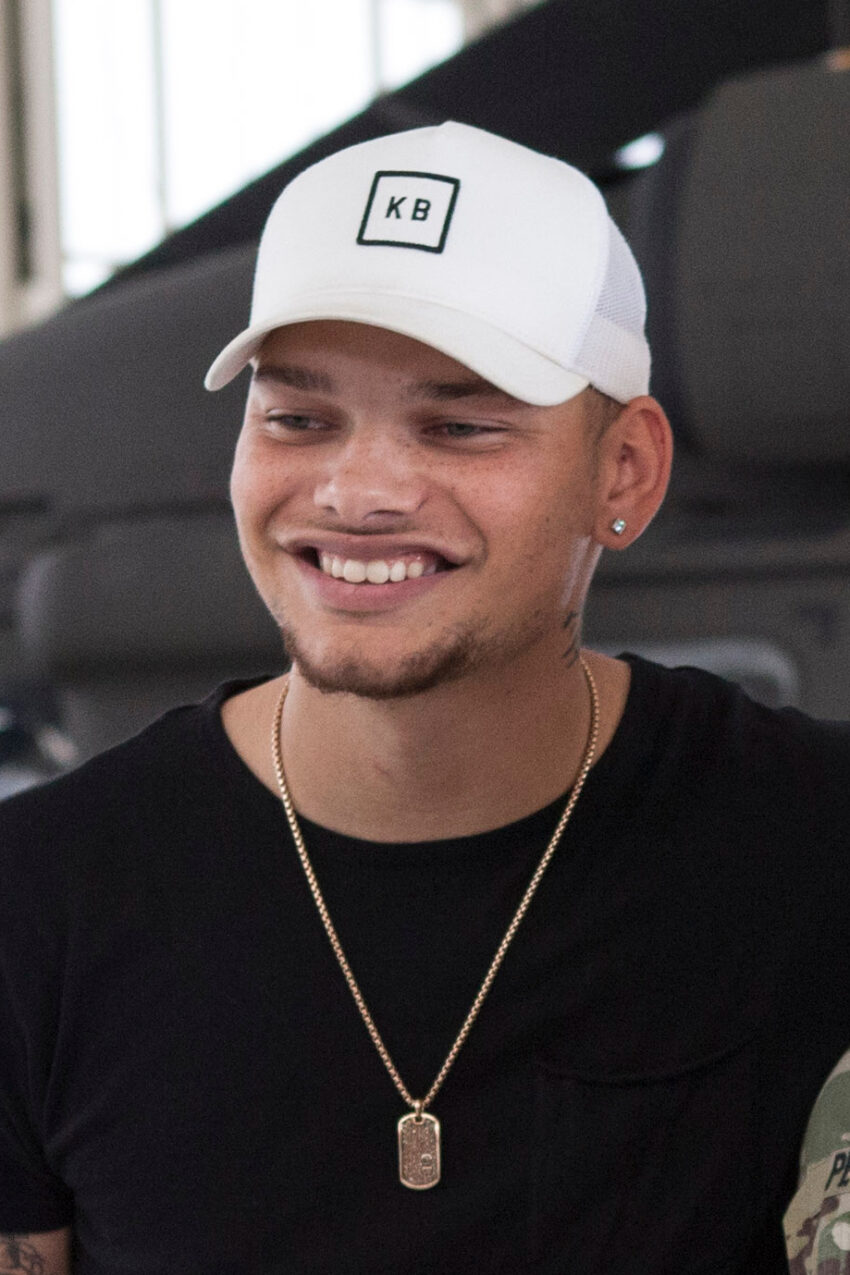 Country music singer Kane Brown takes a photo with a California Army National Guard soldier, Sept. 7, 2018, in a UH-60 Black Hawk hangar at Joint Forces Training Base, Los Alamitos, California. Brown filmed the video for his new song, "Homesick," in the hangar earlier in the morning. (U.S. Air National Guard photo by Senior Airman Crystal Housman)