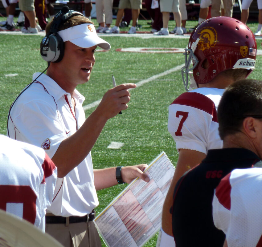 USC Trojans football Head Coach Lane Kiffin talks to Trojans quaterback Matt Barkley (No. 7) during a game in the 2010 USC Trojans football season.
