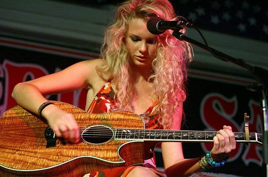 Taylor Swift, with her Taylor acoustic guitar made of acacia koa wood, at the Maverick Saloon & Grill in Santa Maria, California, June 16, 2006.
