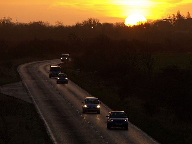 Another Workday Begins, south of Hedon, East Riding of Yorkshire, England.The morning commuters head westwards along the A1033 from the south Holderness area towards Hull with the early morning sun peeping over the horizon.