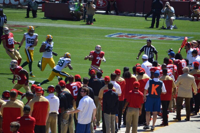 San Francisco 49ers quarterback Colin Kaepernick scrambles with the ball against the Green Bay Packers in both teams' season opener.