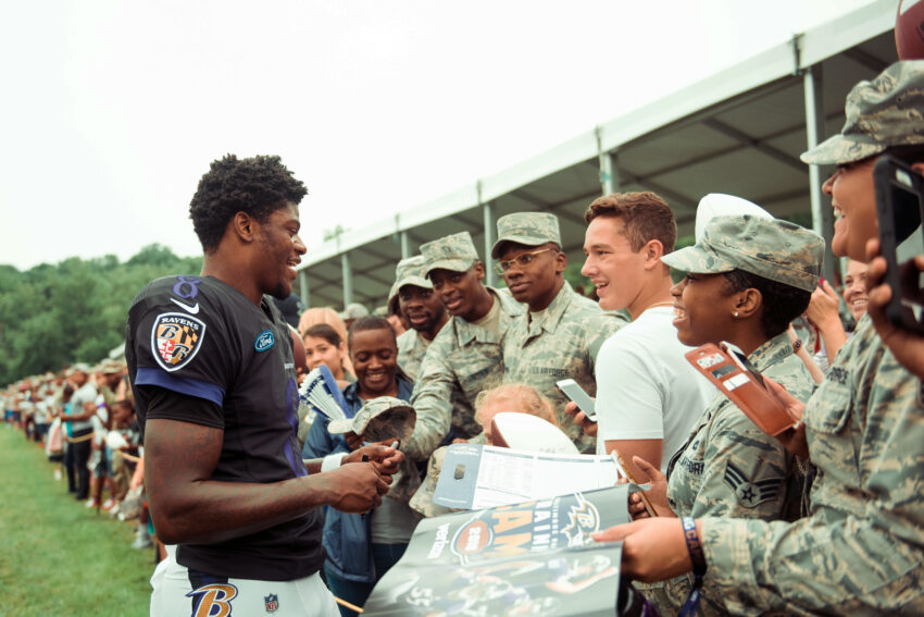 Lamar Jackson, Baltimore Ravens quarterback, interacts with service members after practice at Ravens Training Camp Facility in Owings Mills, Md., July 30, 2018. More than 1,000 service members from throughout the National Capital Region filled the stands to watch as players and coaches ran a variety of drills and scrimmages.